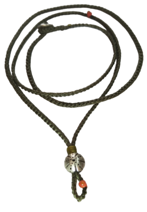 thin cord necklace (multi jewelry) on khaki with sea urchin.