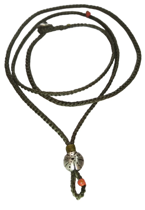 thin cord necklace (multi jewelry) on khaki with sea urchin.