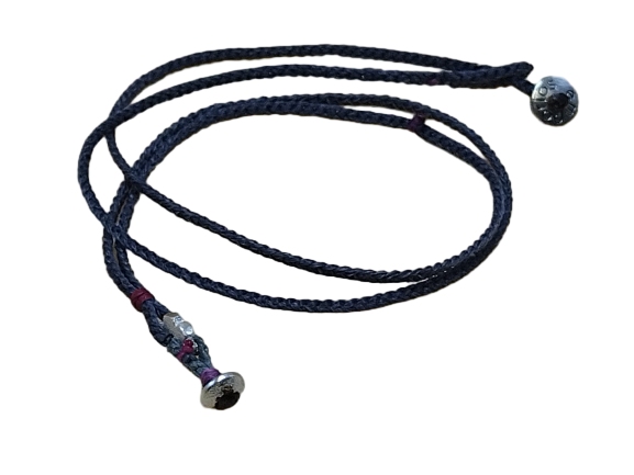 thin cord necklace (multi jewelry) on coal with two geometric beads.