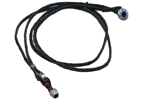 thin cord necklace (multi jewelry) on khaki with two geometric beads.